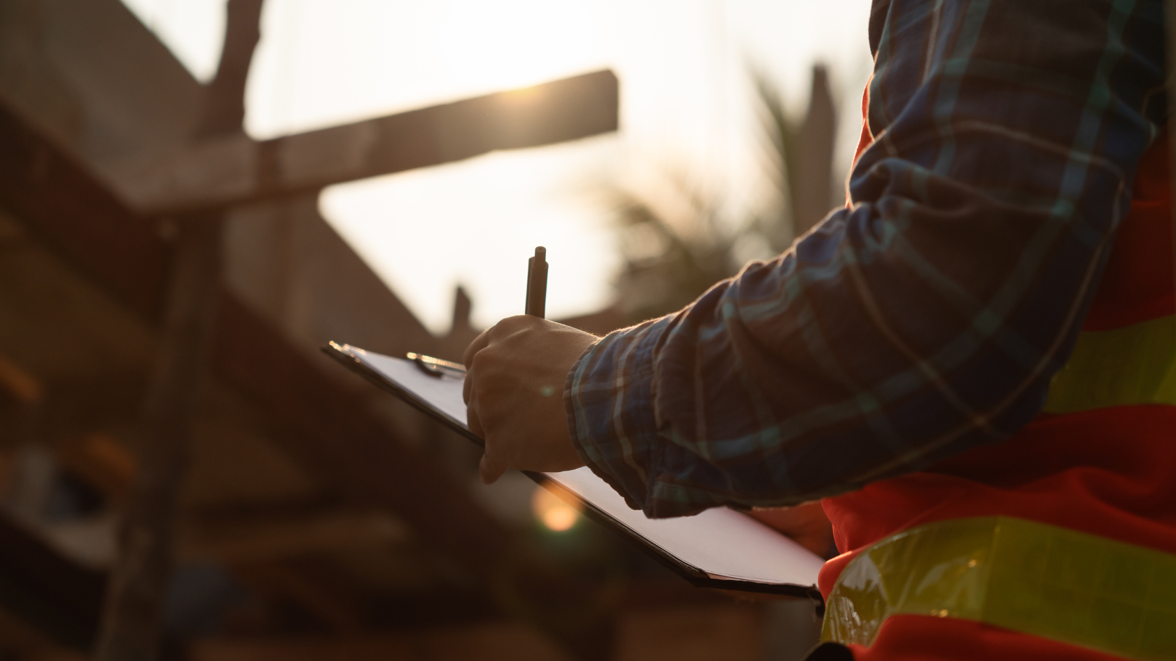 A construction worker writing on a piece of paper