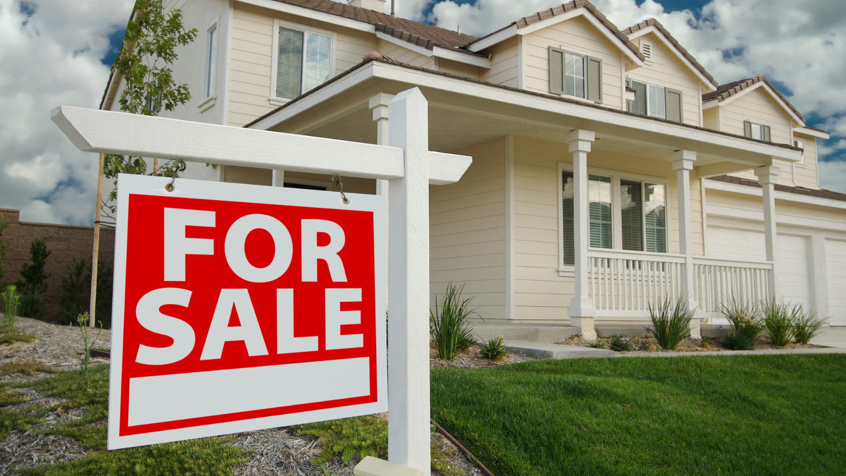 A for sale sign in front of a house