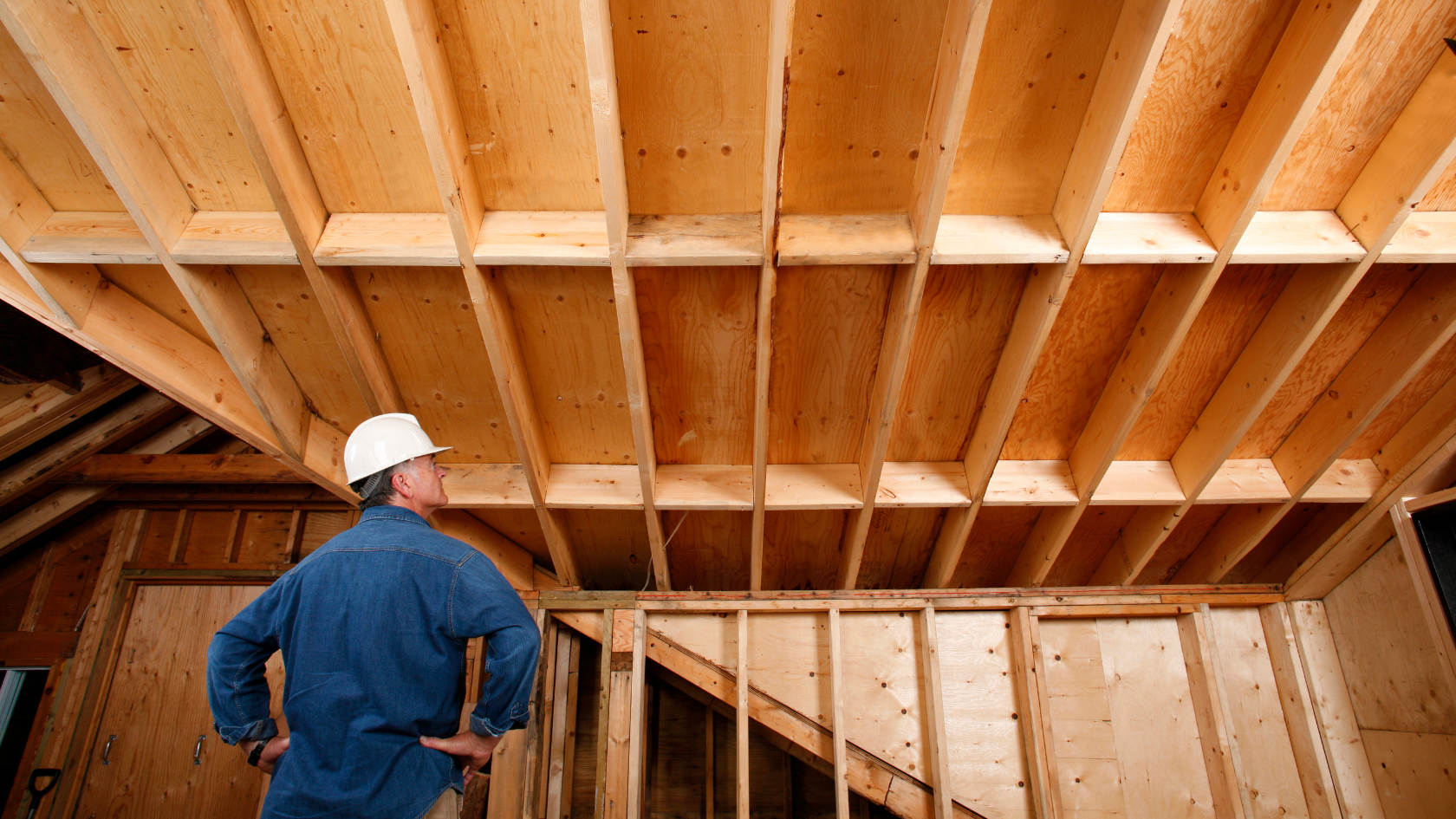 A man standing in a room under construction