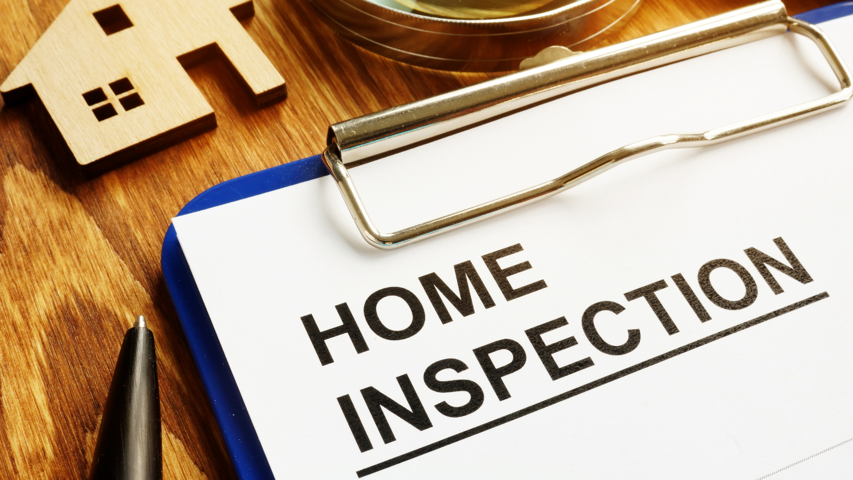 A clipboard with the words home inspection on it